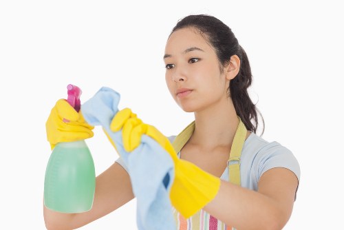 Technician preparing carpet cleaning equipment safely indoors