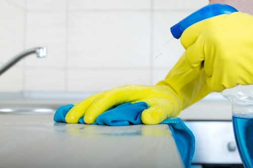 Experienced cleaner in Kingston upon Thames maintaining a tidy office workspace